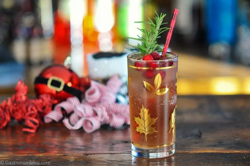 Cranberry Mocktail in gold leaf glass for Christmas, Christmas stuff behind
