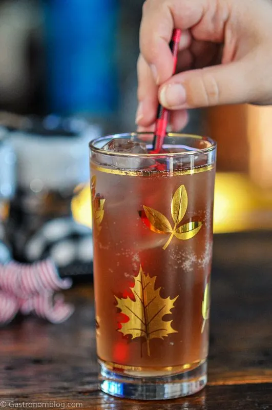Cranberry Mocktail in gold leaf glass for Christmas, Christmas stuff behind
