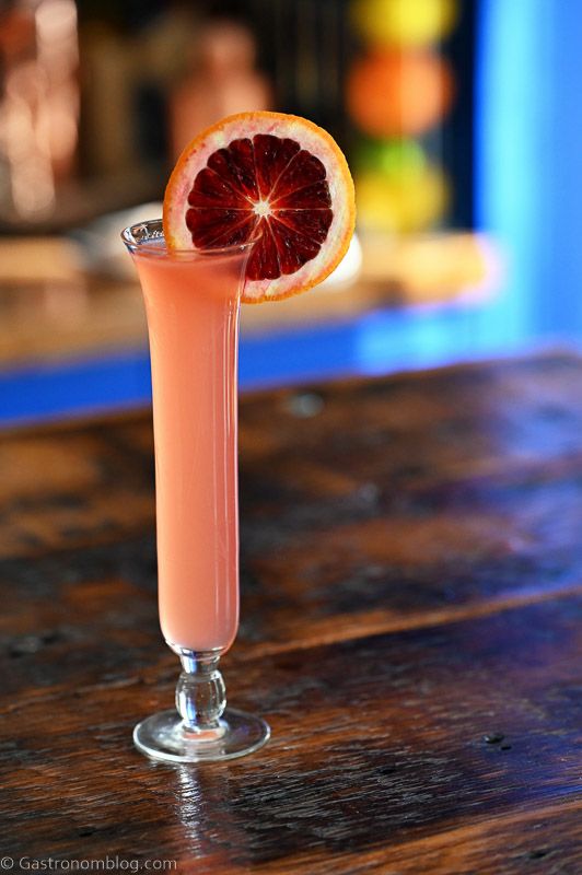 Blood Orange Gimlet, a pink cocktail with blood orange wheel garnish