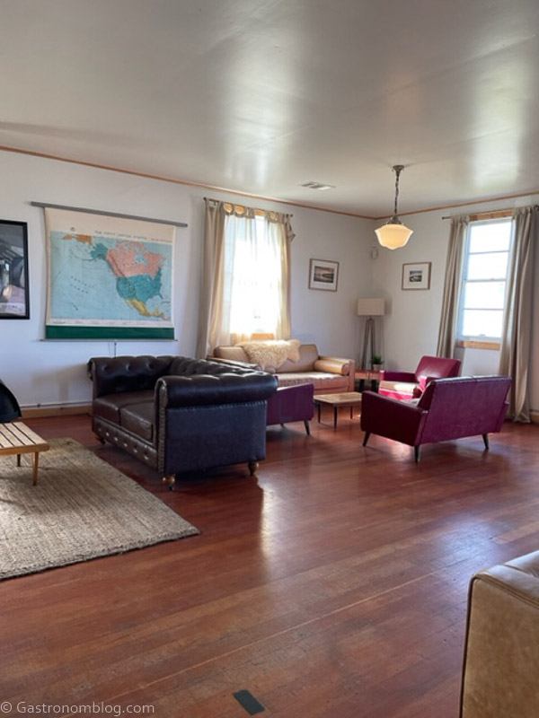 Inside of Humboldt Bay Social Club, wooden floors, vintage sofa and chairs, vintage decor
