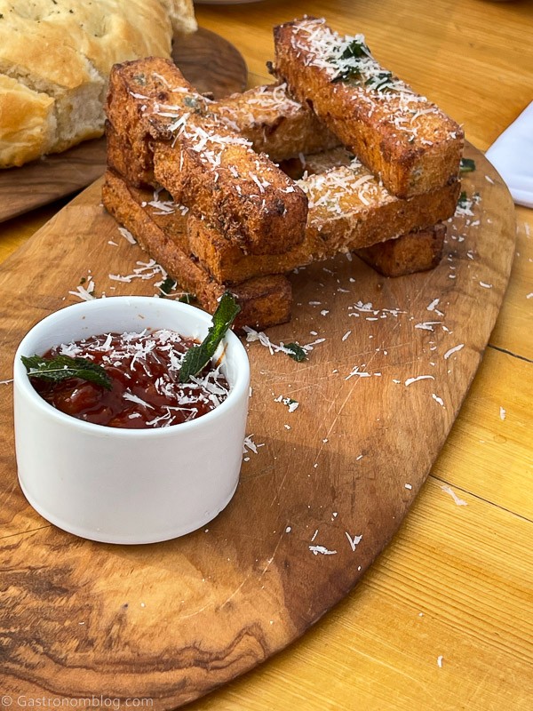 polenta fries with spicy ketchup in white ramekin on wooden platter at Boulder Mountain Guest Ranch and Sweetwater Kitchen