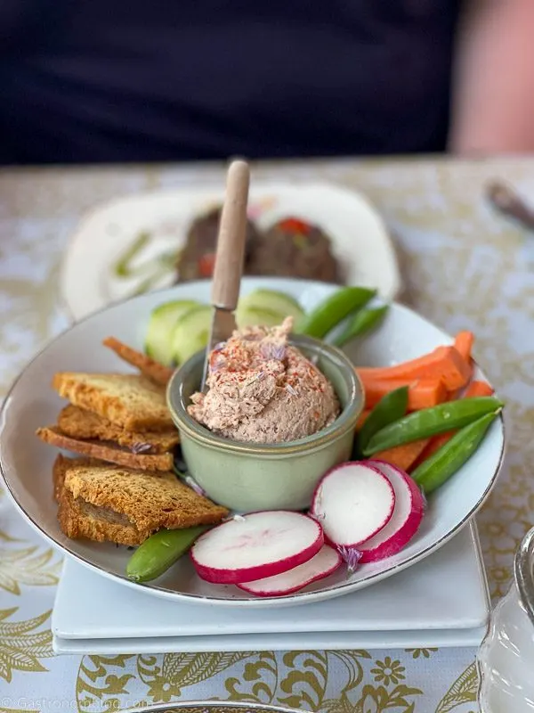 trout pate in green stoneware with veggies in bowl