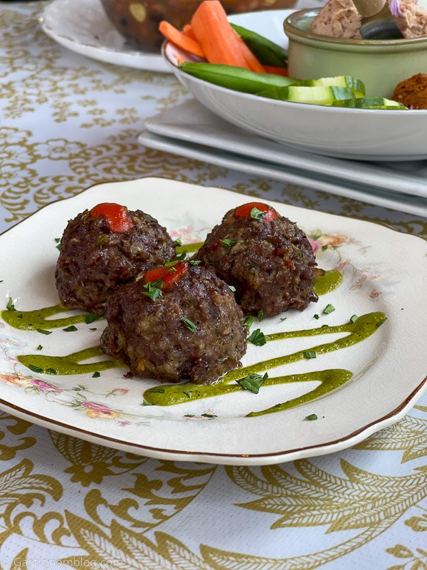 meatballs with green sauce on white plate