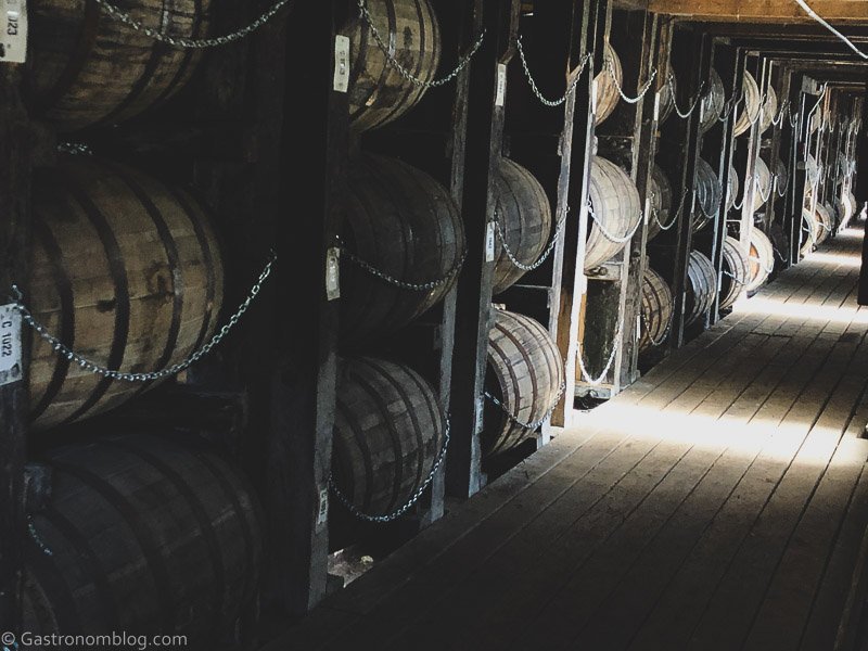 Inside of rickhouse at Hollday Distillery, barrels lined up in stacks