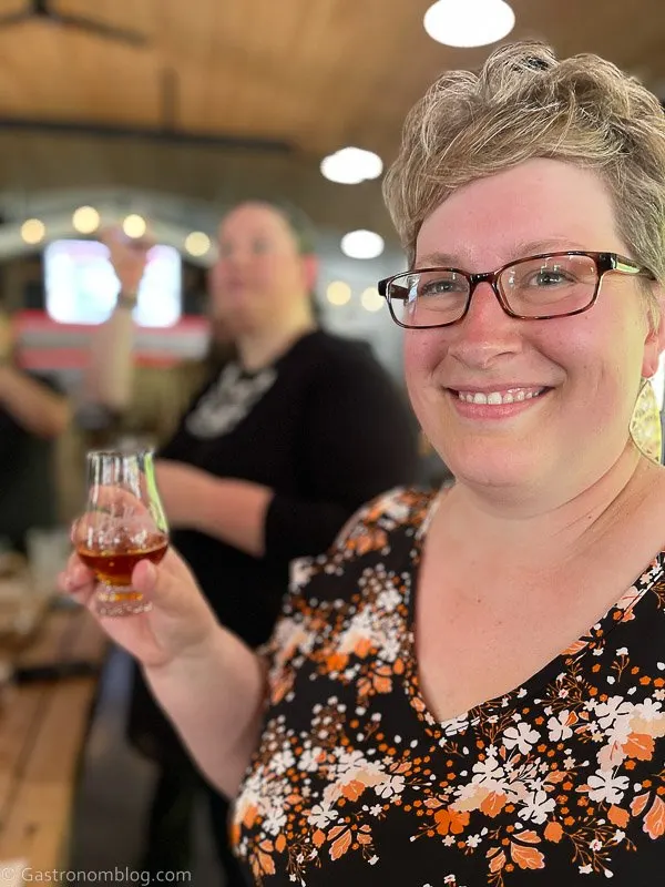 Woman holding whiskey tasting glass
