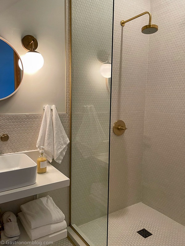 Shower in bathroom at Hotel Alma Minneapolis, sink on left side
