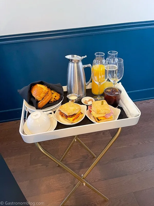Tray with brunch items in blue hallway at Hotel Alma Minneapolis