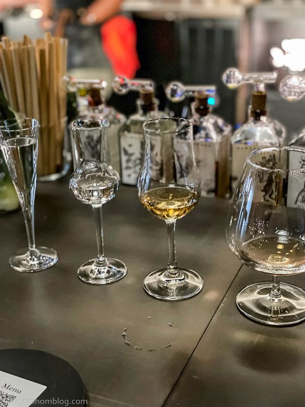 line of glasses on bar top with tastings of brandy