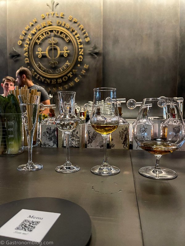 Line of glasses on bar top with brandy tastings in them