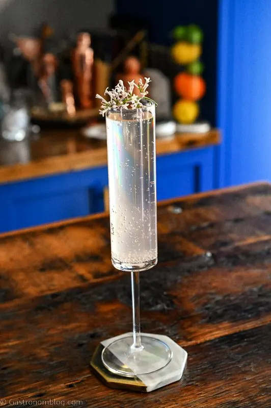Hazy pink cocktail in tall glass on wood table