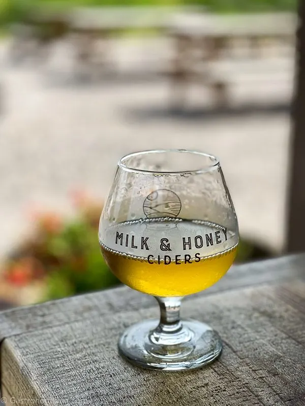 Glass of cider on table at Milk and Honey Ciders