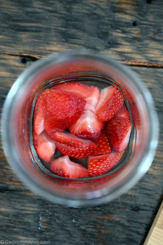 Top view of Strawberries in liquid in jar