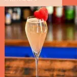 Strawberry Mimosa, Pink bubbly cocktail in flute with strawberry garnish on the side