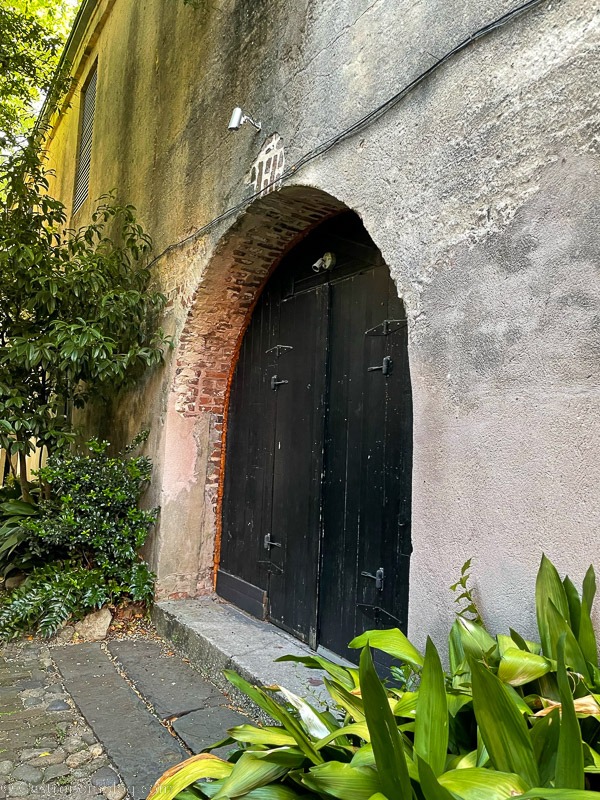 black door in stone wall in Charleston, South Carolina