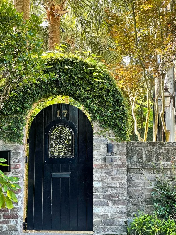 stone wall with black gate door in Charleston, South Carolina