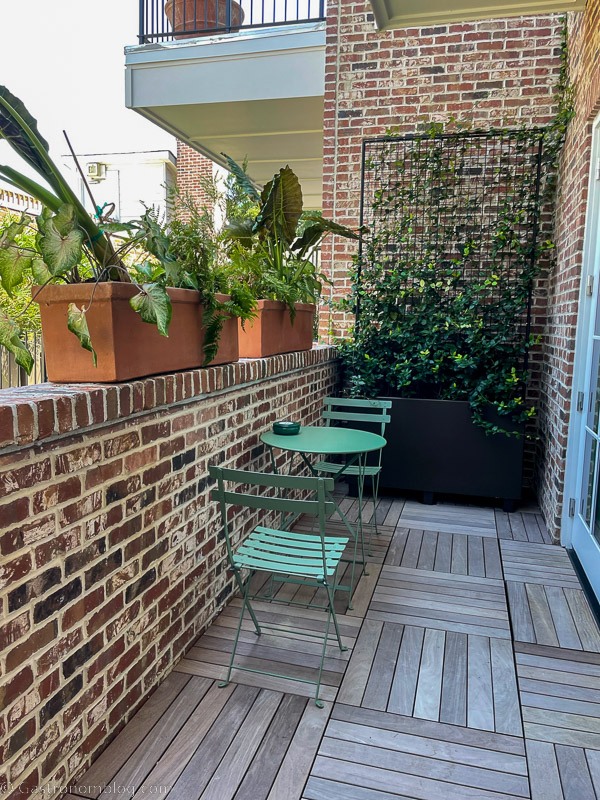 balcony at The Pinch Charleston, light green table and chairs with plants on the sill