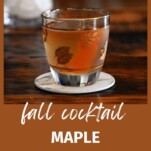 tan maple Old Fashioned cocktail in leaves glass on white coaster on wooden table