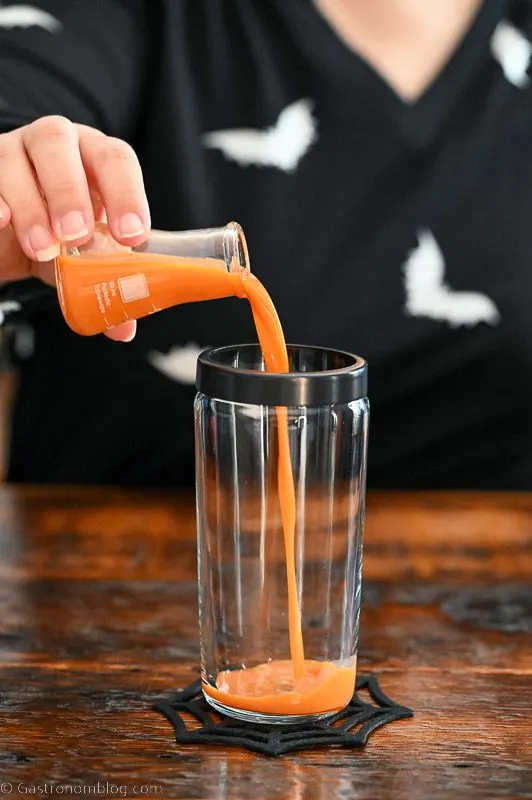 orange pumpkin liqueur being poured into cockgtail shaker