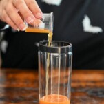 orange pumpkin liqueur being poured into cockgtail shaker