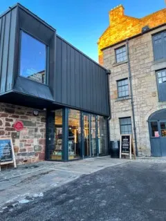 outside of Holyrood Distillery, stone and metal building