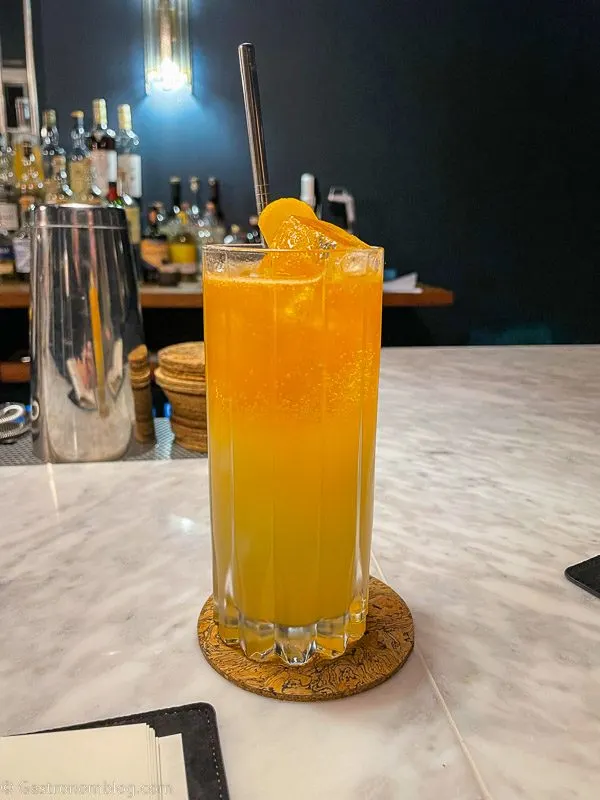 Bright yellow cocktail on white marble bar at Killiecrankie House