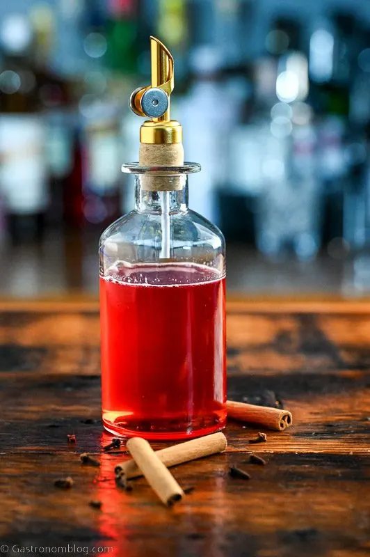Red Spiced Cranberry Simple Syrup in gold topped bottle