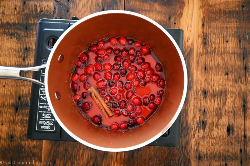 top shot of cranberries and spices in saucepan for spiced cranberry simple syrup