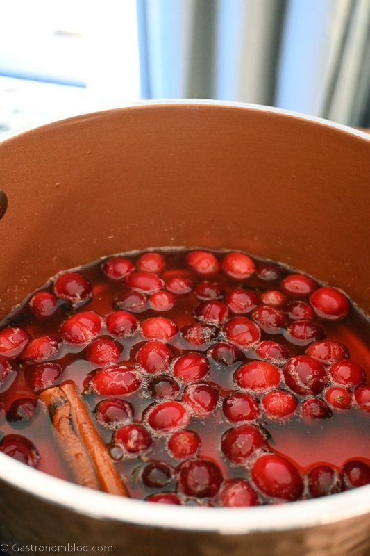 top shot of cranberries and spices in saucepan for spiced cranberry simple syrup