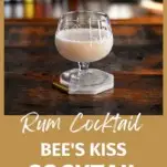 Cream colored Bee's Kiss Cocktail in glass on gold coaster