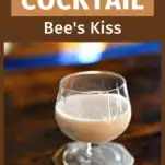Cream colored Bee's Kiss Cocktail in glass on gold coaster