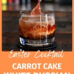 Orange and brown carrot cake cocktail in rocks glass with separate layers, spoon stirring
