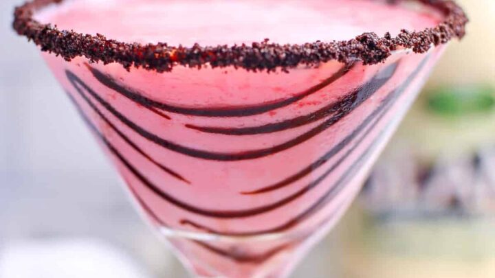 Pink cocktail in martini glass with chocolate sauce