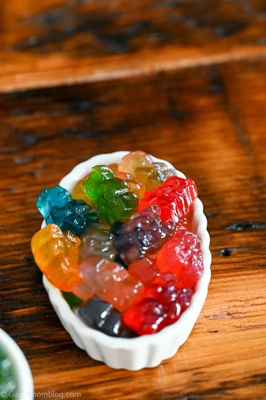 colorful gummy bears in a white ramekin