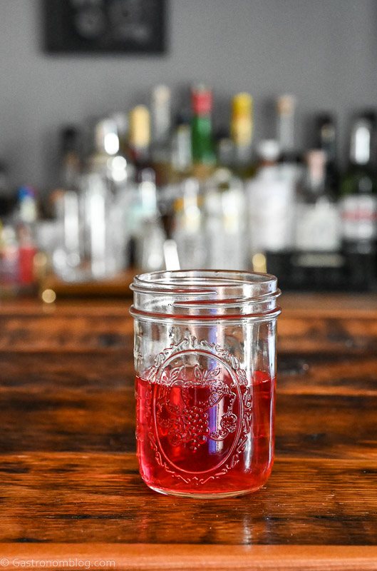 Rhubarb infused vodka, pink liquid in a glass jar