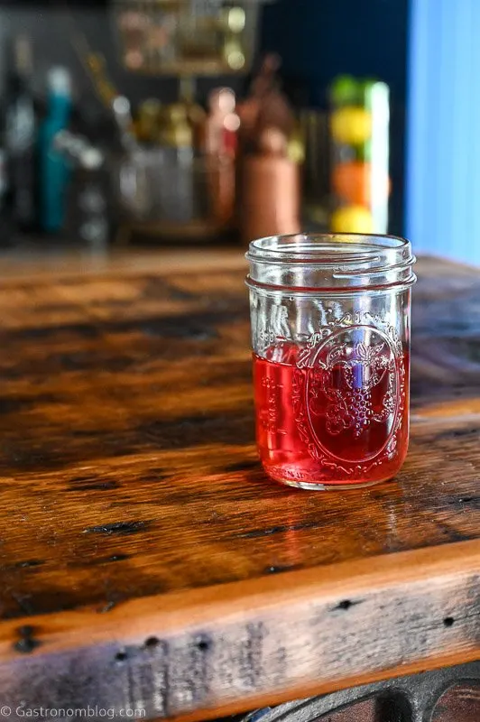 Rhubarb infused vodka, pink liquid in a glass jar