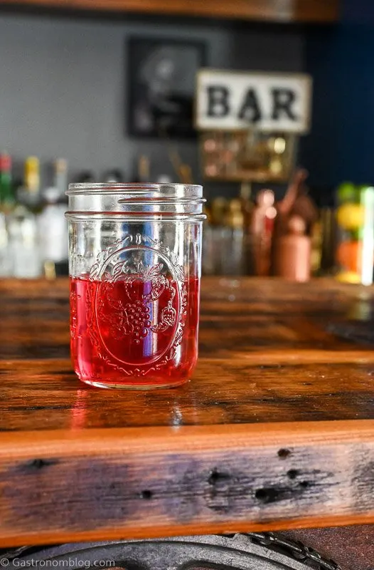 Rhubarb infused vodka, pink liquid in a glass jar