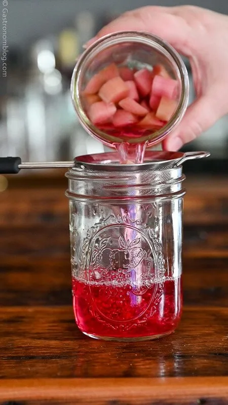 Rhubarb infused vodka, pink liquid in a glass jar