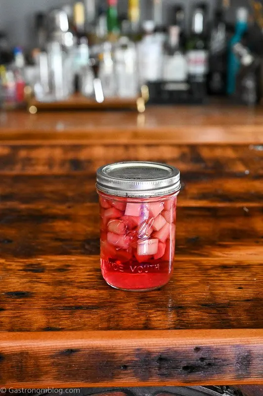 rhubarb pieces in vodka in a glass jar