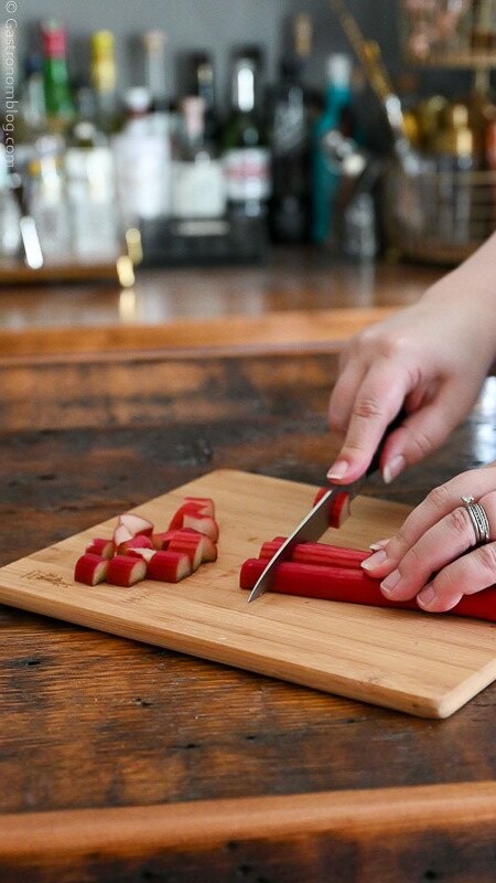 cutting rhubarb on a wooden cutting board