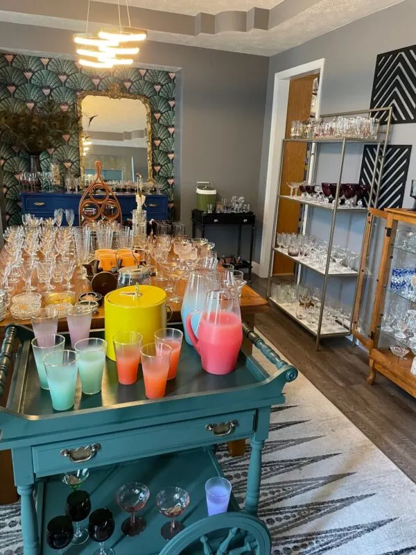 vintage glassware on shelves and carts and on display