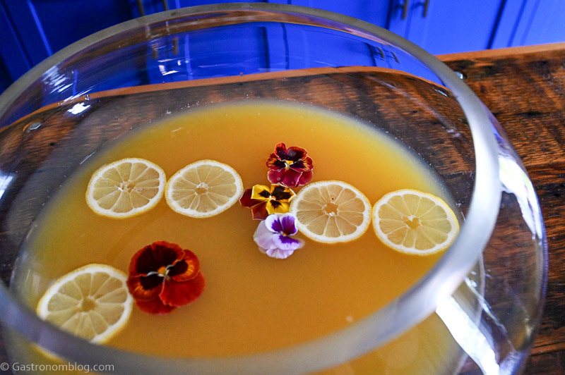Yellow Pineapple Wine Punch with edible flowers and citrus slices