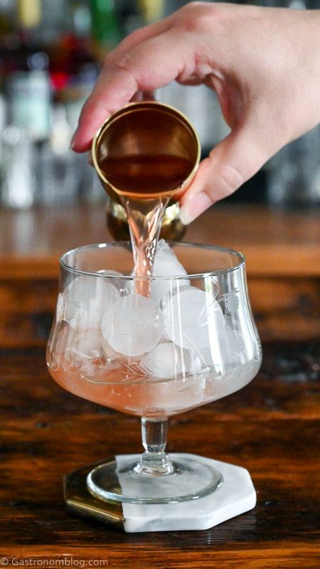 Aperol being poured into glass with ice