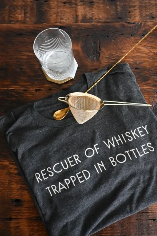 whiskey shirt, glass and strainer flatlay