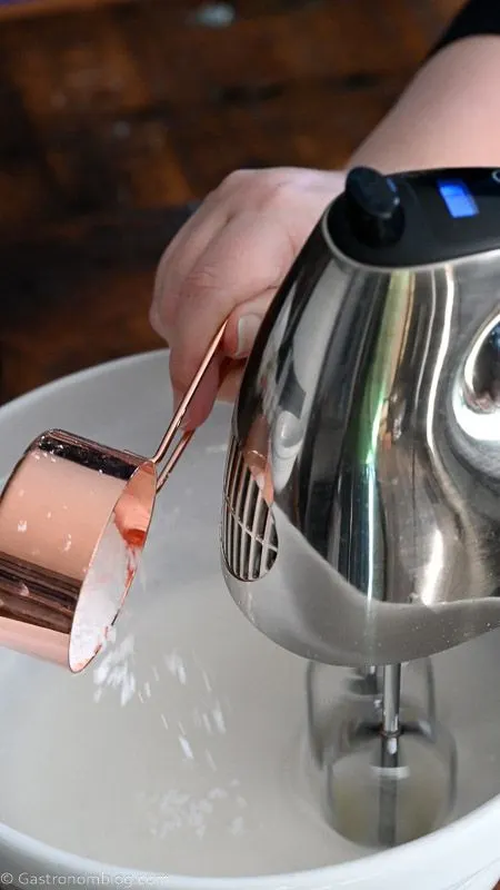 hand mixer being used in a bowl with powdered sugar