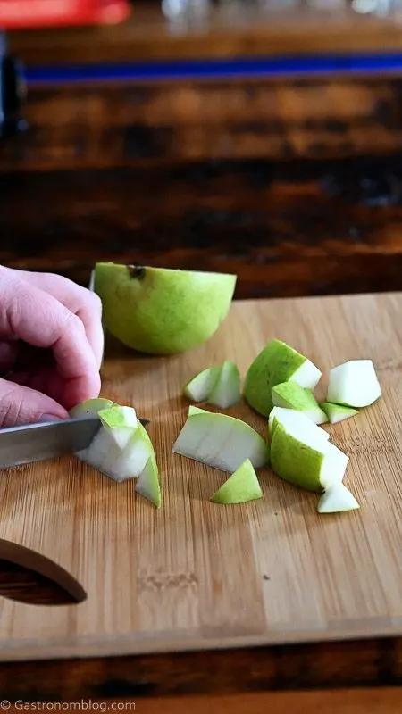 cutting pear on wooden cutting board