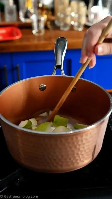 pear syrup cooking in copper saucepan