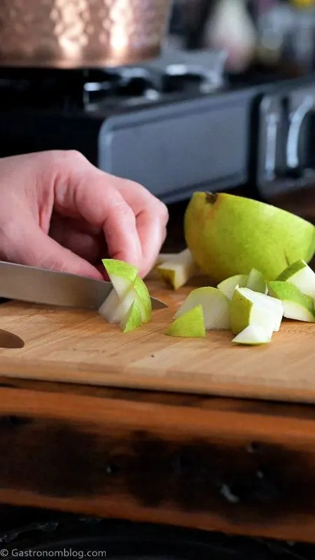 cutting pear on wooden cutting board