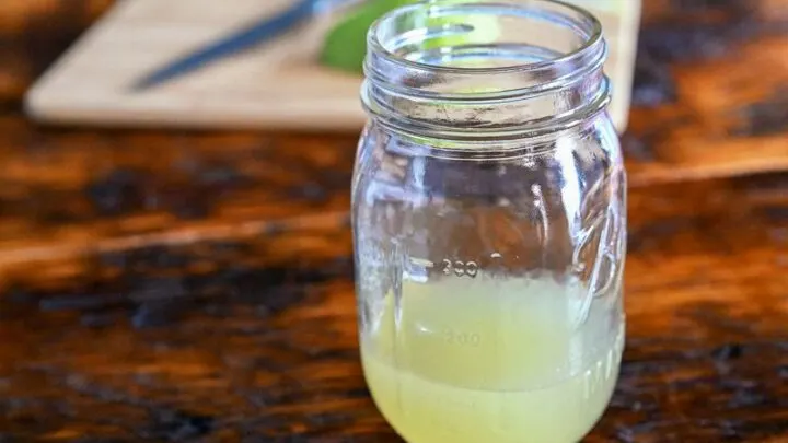 gold colored pear syrup in mason jar on wooden table