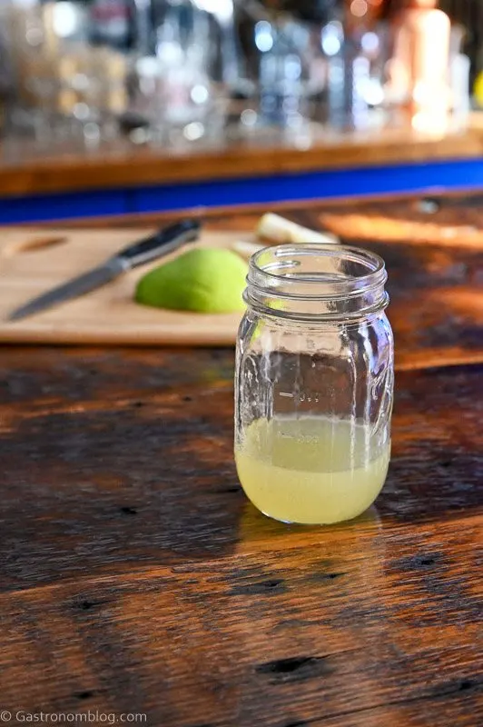 gold colored pear syrup in mason jar on wooden table