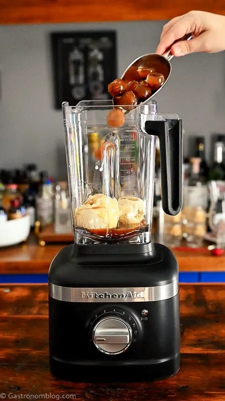 adding coffee ice cubes into blender with ice cream